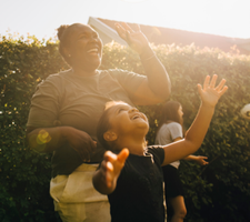 A woman and child laughing outside.